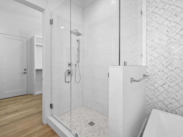 bathroom with wood-type flooring and separate shower and tub