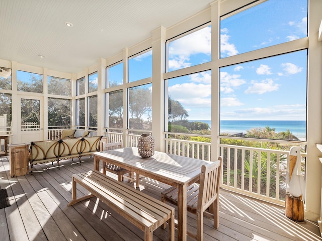 sunroom / solarium with a water view