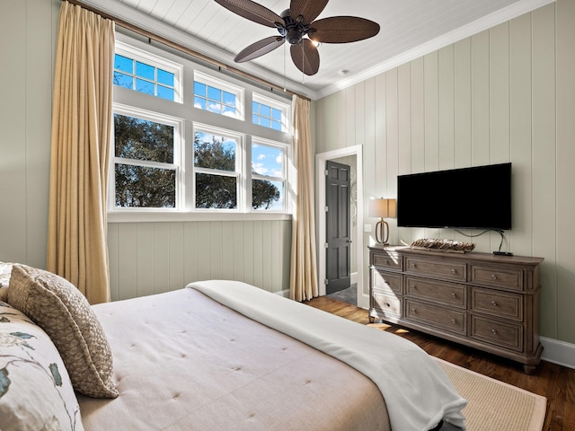 bedroom featuring dark wood-type flooring, ceiling fan, and crown molding