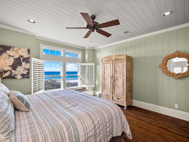 bedroom with dark hardwood / wood-style flooring, ornamental molding, ceiling fan, and a water view