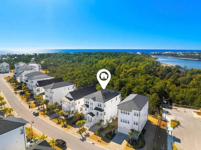 bird's eye view with a forest view, a water view, and a residential view