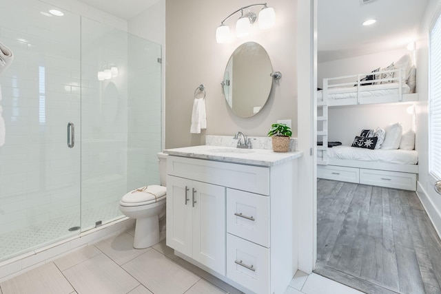 bathroom with vanity, an enclosed shower, and toilet