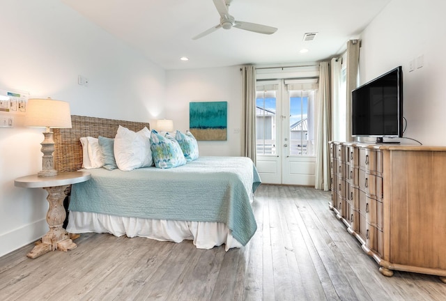 bedroom featuring access to outside, light hardwood / wood-style floors, french doors, and ceiling fan