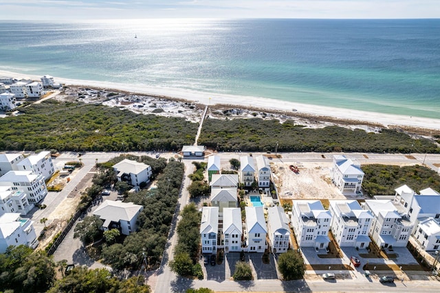 birds eye view of property with a water view and a view of the beach