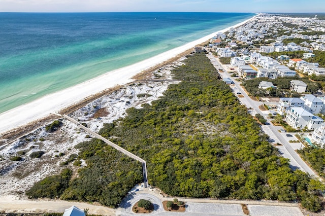 aerial view with a water view and a beach view