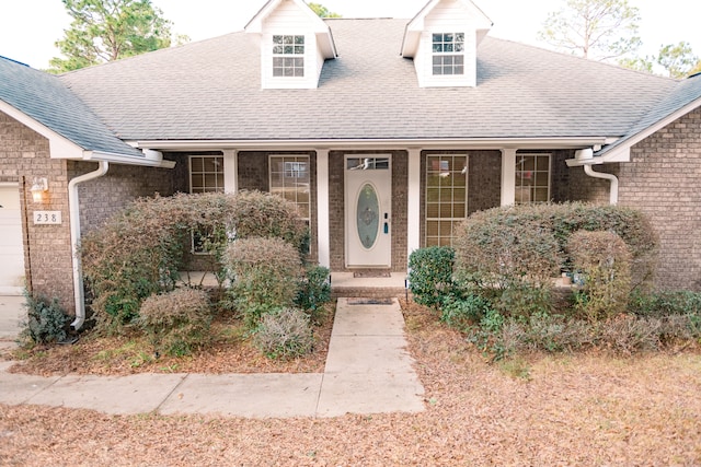 view of front of home featuring a porch and a garage