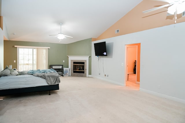 bedroom with ceiling fan, high vaulted ceiling, light colored carpet, and a fireplace