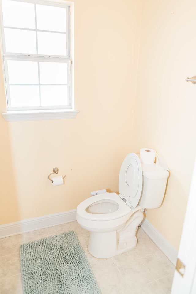 bathroom with tile patterned flooring and toilet