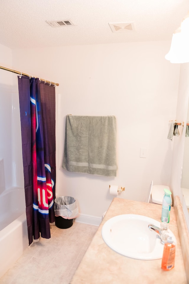 bathroom with shower / tub combo, vanity, tile patterned flooring, and a textured ceiling