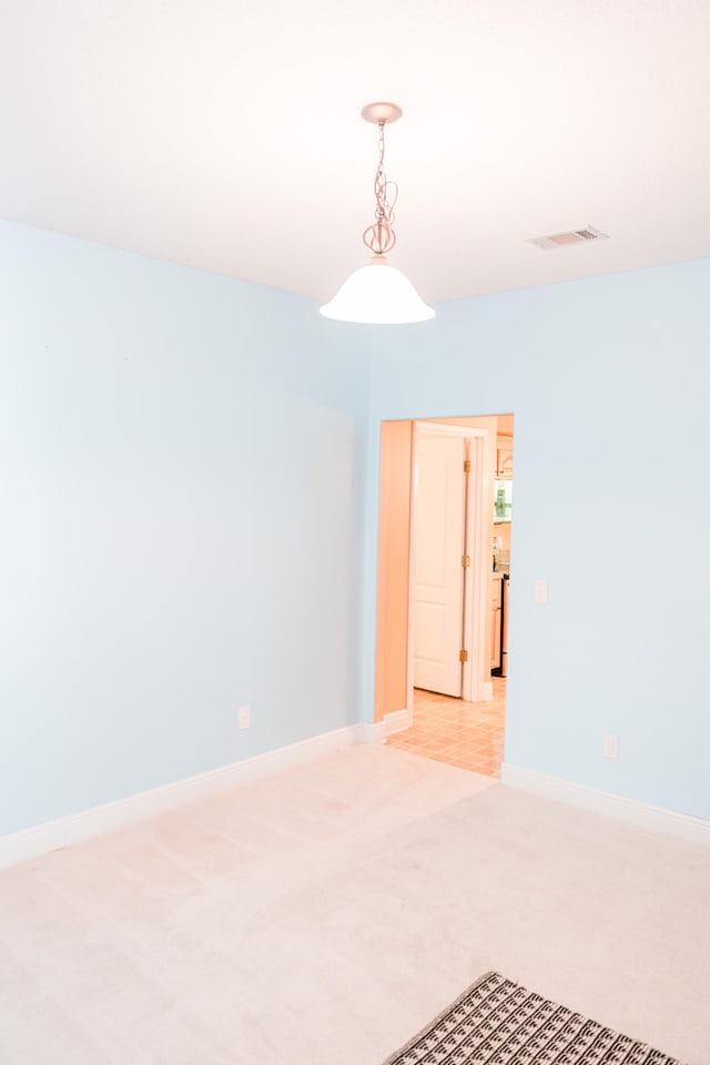 empty room featuring light colored carpet