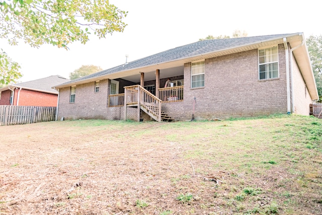 rear view of house with a lawn