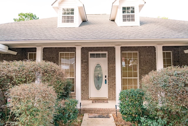 view of exterior entry with covered porch