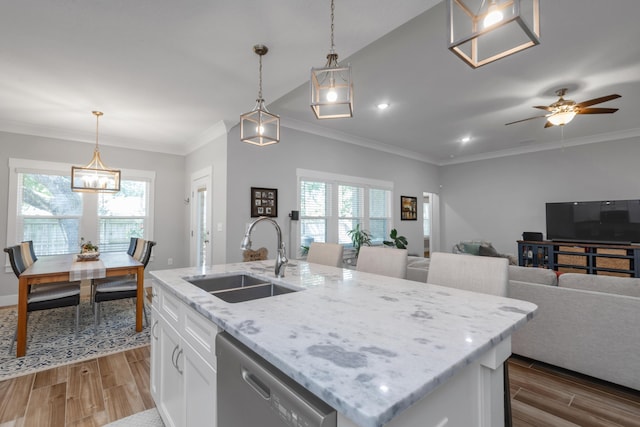 kitchen with a sink, white cabinets, open floor plan, dishwasher, and an island with sink