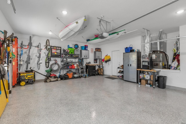 garage featuring baseboards, a workshop area, and a garage door opener