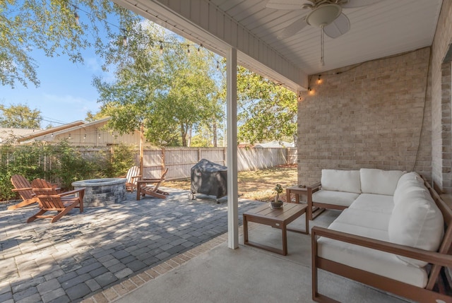 view of patio with a ceiling fan, area for grilling, a fenced backyard, a jacuzzi, and outdoor lounge area