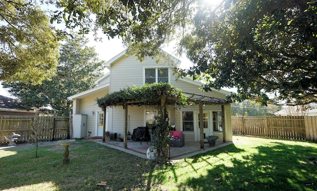 back of property featuring a pergola, a patio, and a lawn