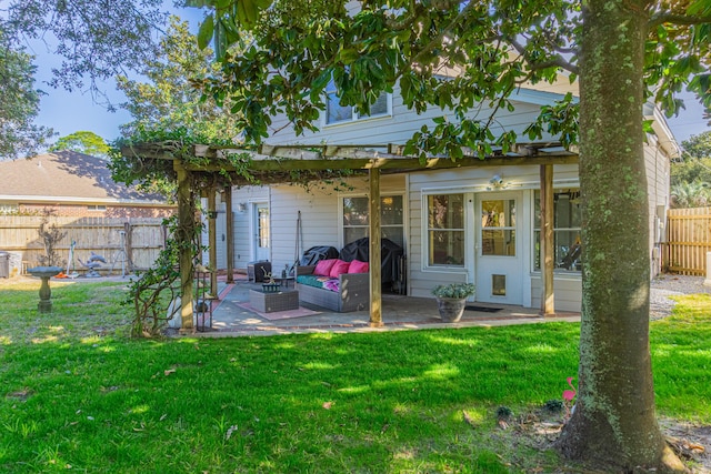 back of property with an outdoor living space, a patio, and a yard