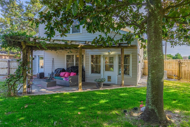 back of property featuring an outdoor hangout area, a patio, and a lawn