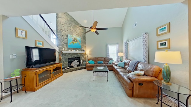 living room featuring ceiling fan, high vaulted ceiling, light colored carpet, and a fireplace