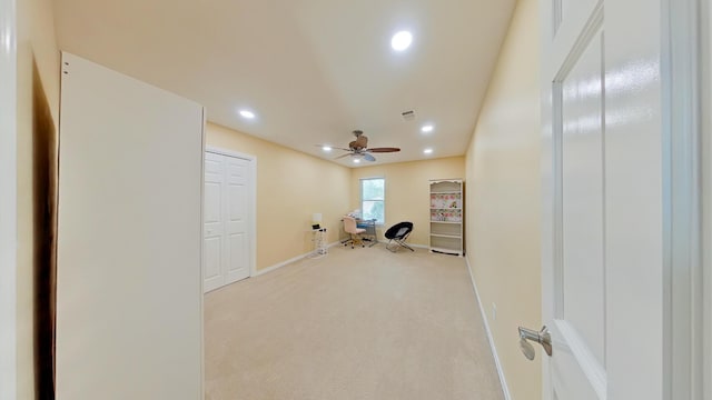 workout room with light colored carpet and ceiling fan