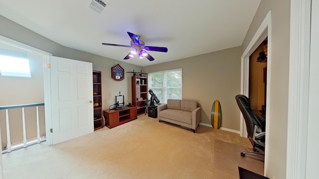 office space featuring ceiling fan and light colored carpet