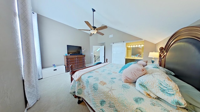 bedroom featuring ceiling fan, high vaulted ceiling, ensuite bathroom, carpet, and a barn door