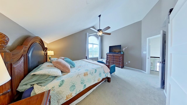 bedroom with light carpet, vaulted ceiling, a barn door, and ceiling fan