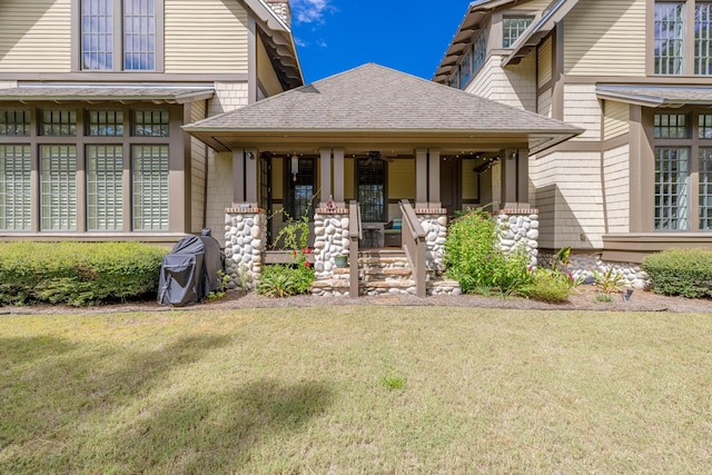 view of exterior entry featuring a yard