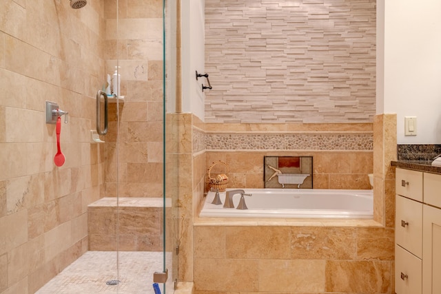 bathroom with vanity and shower with separate bathtub