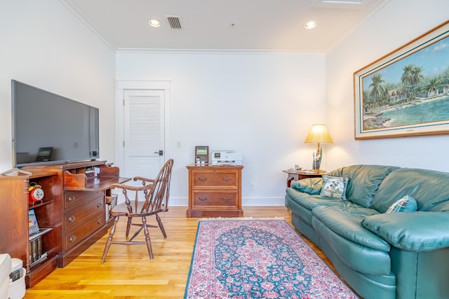 living room with ornamental molding and light wood-type flooring