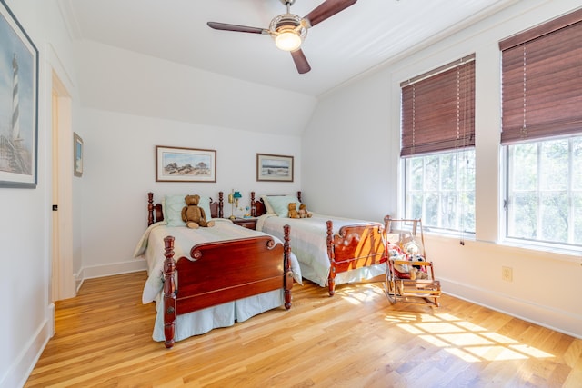 bedroom featuring lofted ceiling, ceiling fan, and light wood-type flooring