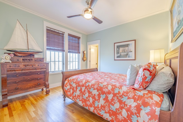 bedroom featuring ceiling fan, ornamental molding, and light hardwood / wood-style floors