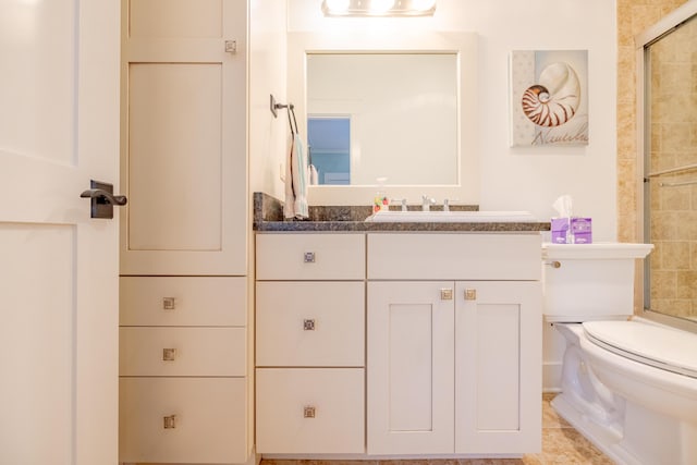 bathroom with tile patterned floors, vanity, toilet, and a shower with shower door