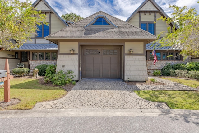 view of front facade featuring a garage and a front lawn