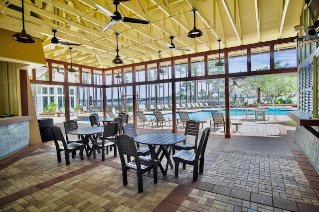 sunroom with plenty of natural light and ceiling fan