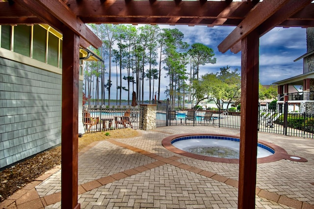 view of patio / terrace with a pool with hot tub