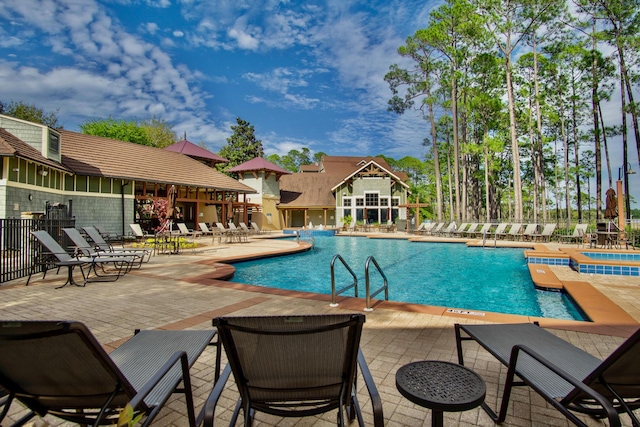 view of swimming pool featuring a patio area