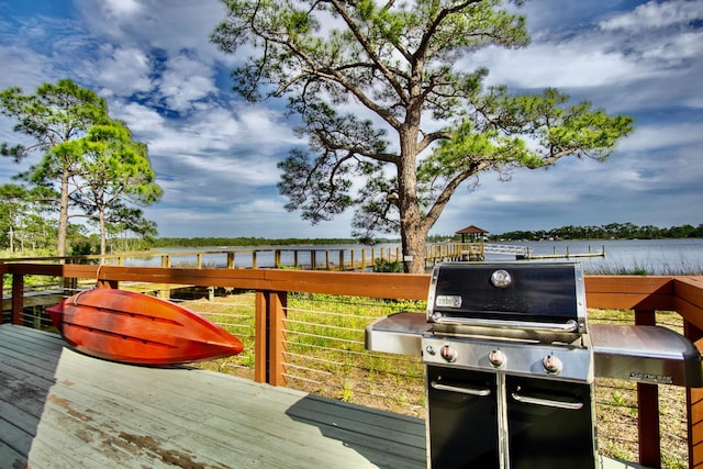 deck featuring area for grilling and a water view