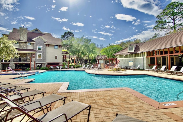 view of swimming pool featuring a patio area