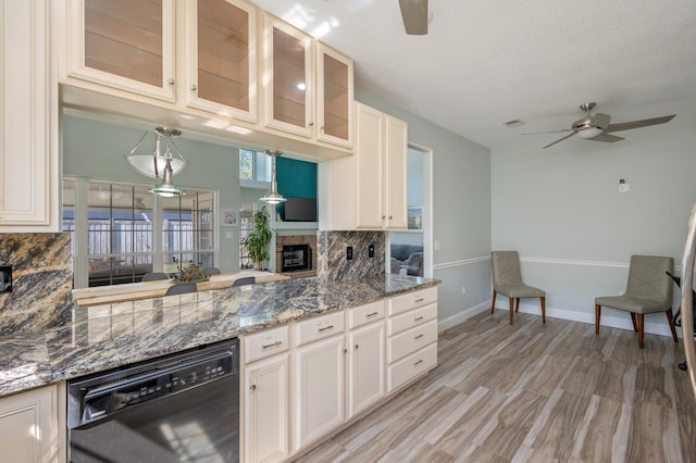 kitchen with decorative light fixtures, backsplash, glass insert cabinets, a ceiling fan, and dishwasher