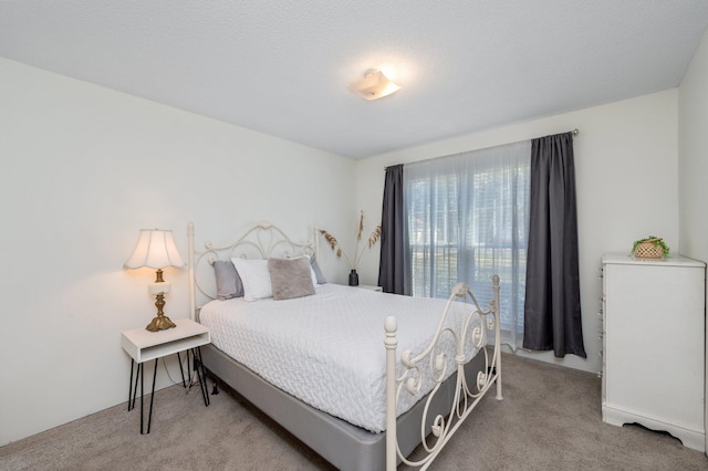 bedroom with carpet floors and a textured ceiling