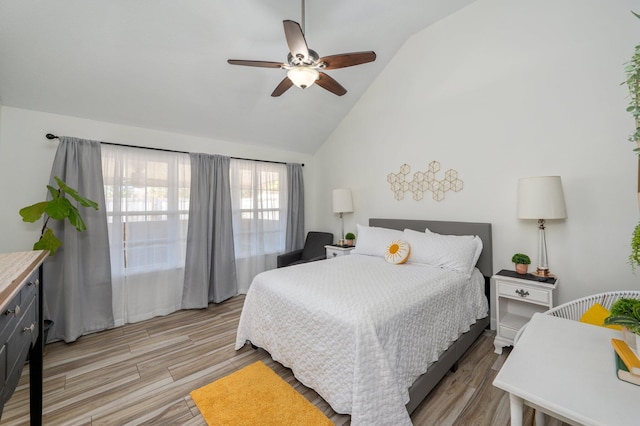 bedroom featuring lofted ceiling, ceiling fan, and light wood finished floors