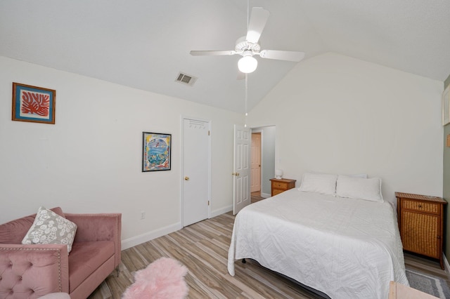 bedroom with baseboards, visible vents, a ceiling fan, vaulted ceiling, and light wood-style floors