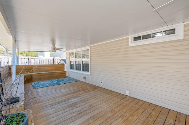 wooden deck featuring ceiling fan and fence