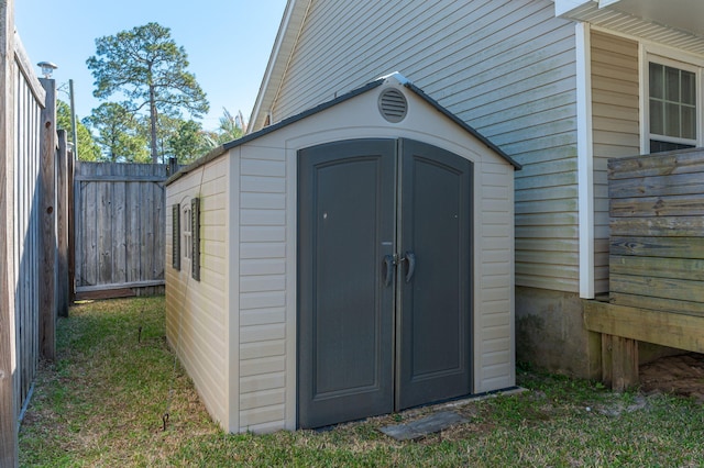 view of shed featuring fence