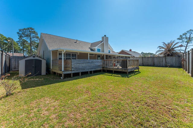 back of house featuring a storage shed, a fenced backyard, an outdoor structure, and a wooden deck