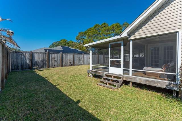 view of yard with a fenced backyard and a sunroom