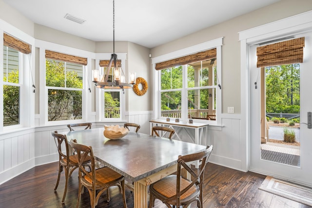 dining room with dark hardwood / wood-style flooring and a wealth of natural light