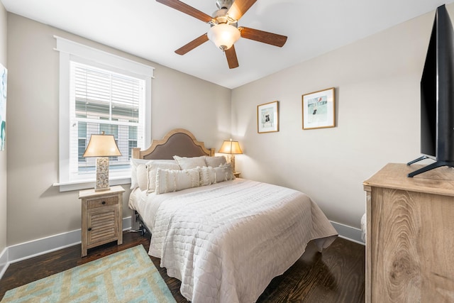 bedroom with dark hardwood / wood-style floors and ceiling fan