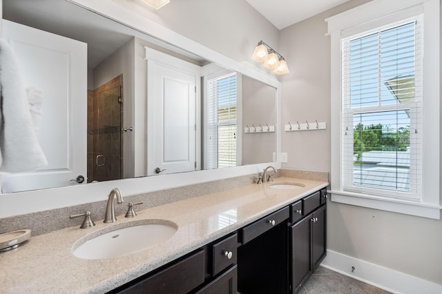 bathroom with vanity, an enclosed shower, tile patterned flooring, and a wealth of natural light